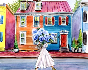 May include: A woman in a white dress walks down a street carrying a bouquet of blue hydrangeas. The street is lined with colorful houses, including a red-roofed house with a blue door.