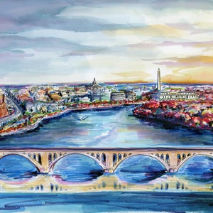 May include: A watercolor painting of the Washington D.C. skyline featuring the Potomac River in the foreground with a multi-arched stone bridge spanning across it. The Washington Monument and the Capitol dome are visible in the distance.