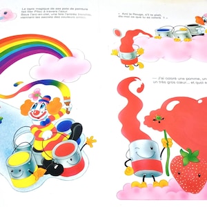 May include: A children's book page illustration featuring a colourful clown painting a rainbow with a brush. The scene includes paint cans, a large red heart, a strawberry, cherries, an apple, and a goldfish in a bowl, all set against clouds.