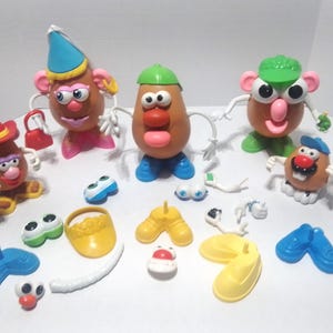 May include: A collection of Mr. Potato Head toys and accessories. The toys have brown potato-shaped bodies with various facial features and accessories, including hats, shoes, and arms. The accessories are in various colors, including blue, yellow, and green.