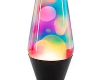 May include: A lava lamp featuring a conical glass vessel filled with multicolored liquid and floating wax shapes. The lamp has a matte black base and a matching black cap, with a vibrant gradient of pink, blue, and yellow hues inside.