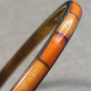 Gold tone bracelet with bone inserts in orange shades, vintage