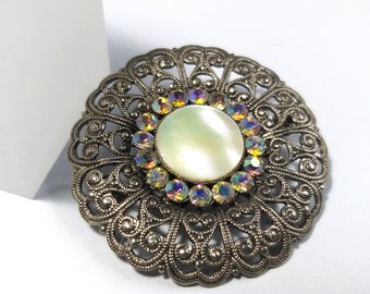 Filigree silver tone brooch, mother-of-pearl brooch, aurora borealis rhinestone brooch vintage