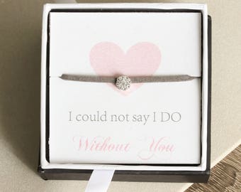 May include: A small grey box with a white interior. The box has a pink heart and the text "I could not say I DO Without You". A grey bracelet with a small sparkly silver charm is inside the box.