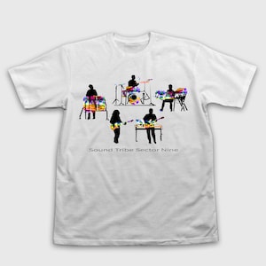 May include: White t-shirt featuring a band silhouette with colorful tie-dye instruments. The text "Sound Tribe Sector Nine" is printed below the band. The band includes a drummer, keyboardist, guitarist, and percussionist.