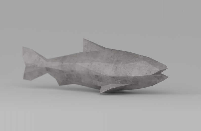 May include: A gray concrete fish sculpture with a geometric design. The sculpture is made of multiple triangular shapes and has a smooth, textured surface.