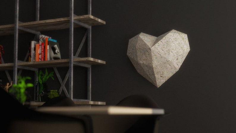 May include: A white, geometric heart-shaped wall sculpture with a textured surface.