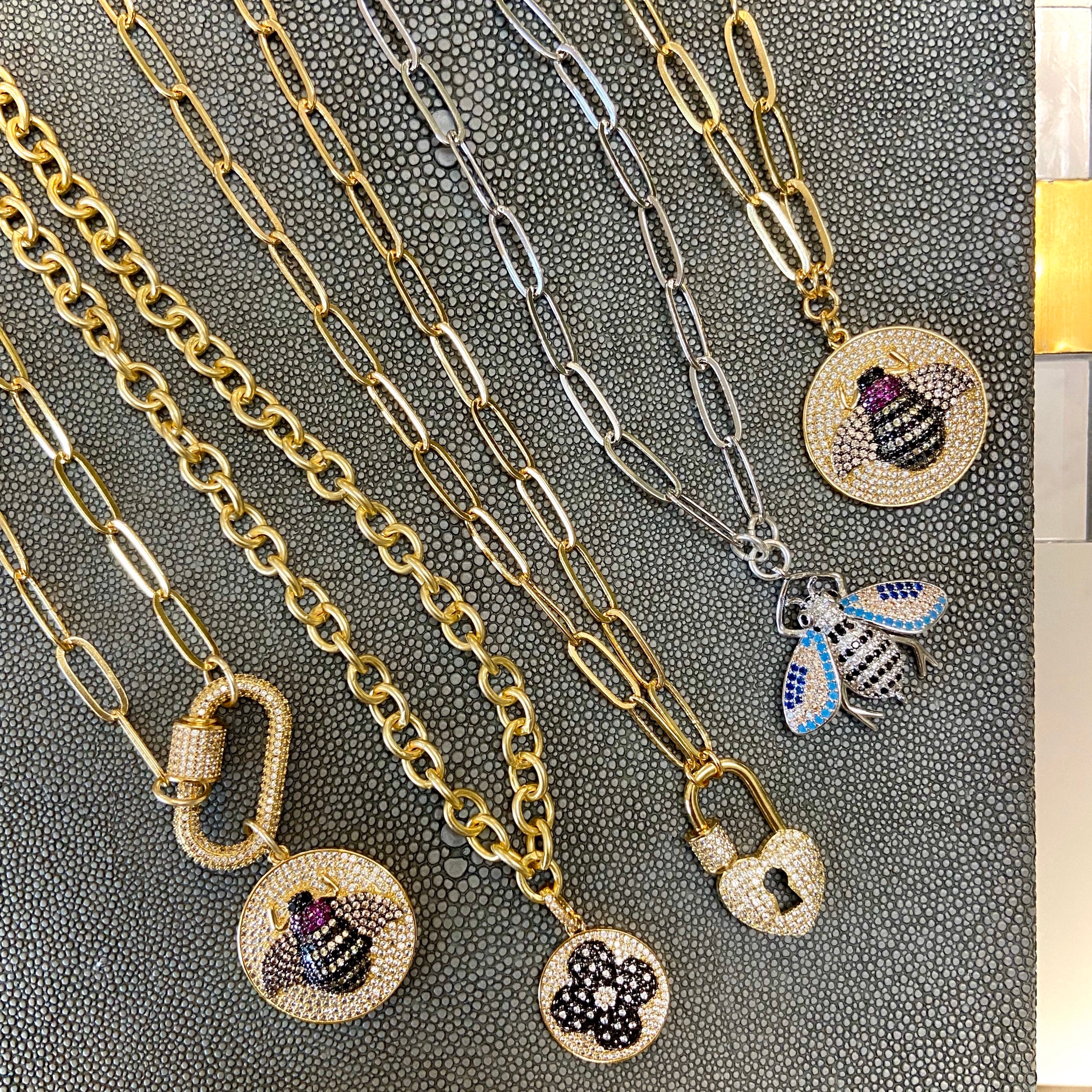 Gold paperclip chain necklace with carabiner clasp and bee pendant