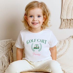 女の子用ゴルフカートプリンセスTシャツ、ユース半袖Tシャツ、プレッピーキッズシャツ、かわいいゴルフトップス、ピンクのゴルフ愛好家へのギフト