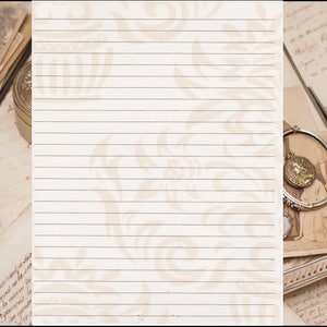 May include: A lined sheet of paper with a vintage floral pattern. The paper is surrounded by old photos, letters, and a silver tray with a locket and a bracelet.