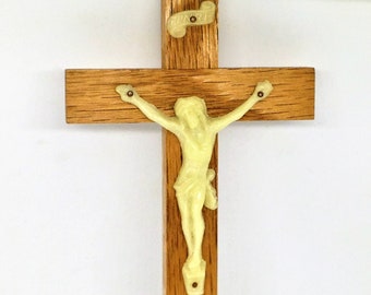 May include: A wooden crucifix with a light yellow plastic figure of Jesus Christ.
