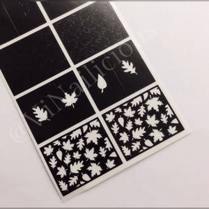 May include: A sheet of black nail stencils with white leaf designs. The stencils feature various leaf shapes, including maple leaves, oak leaves, and simple leaf shapes. The stencils are arranged in a grid pattern on a white background.