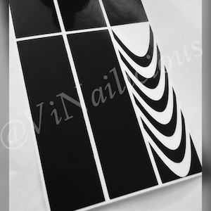 May include: Black and white nail art stickers with a curved design. The stickers are arranged in a grid pattern.