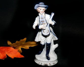 Dresden-style figurine of a young man in period | Victorian dress with a lute. Attributed Taiwan 1960s.