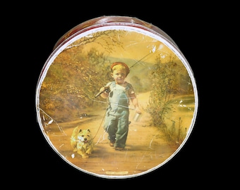 McVitie & Price The Optimist round cookie tin. Young boy and his dog go fishing. Made in England.