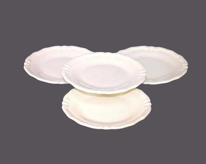 Four Tiffany Boutique L4201 bread plates. All cream embossed scrolls. Made in Italy.