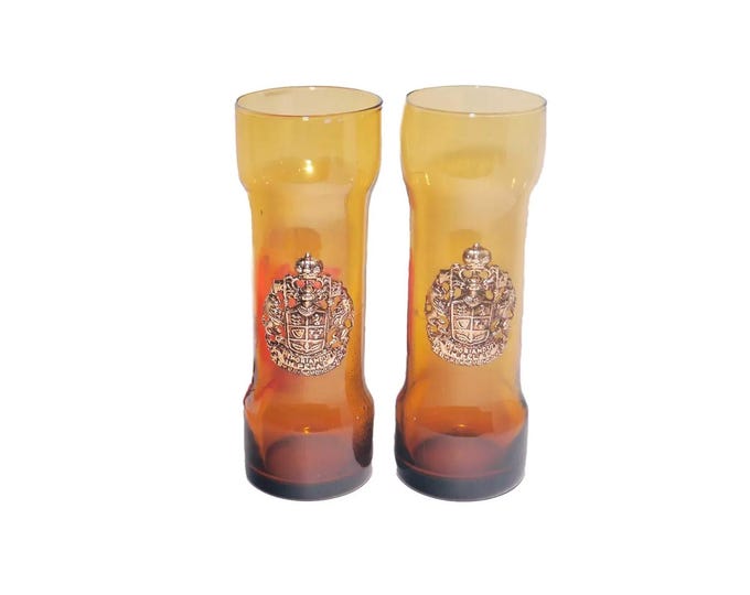 Pair of Memoriandum in Pelae Coat of Arms amber Tom Collins glasses made in Spain. Applique Coat of Arms to front.