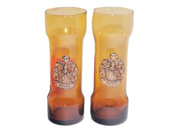 Pair of Memoriandum in Pelae Coat of Arms amber Tom Collins glasses made in Spain. Applique Coat of Arms to front.