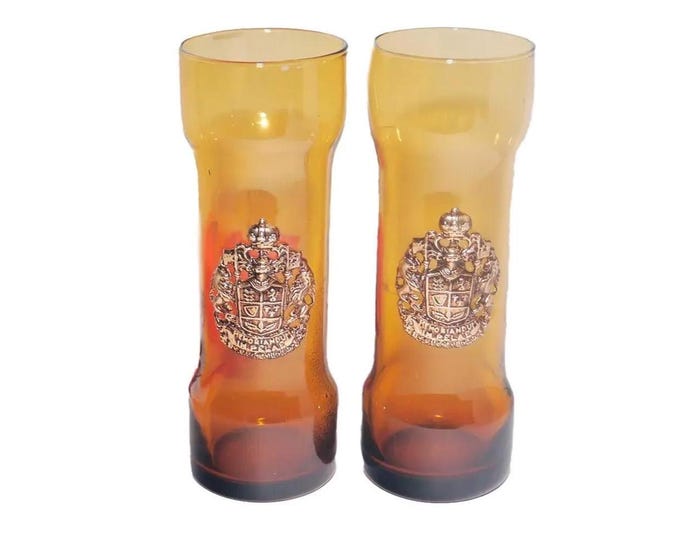Pair of Memoriandum in Pelae Coat of Arms amber Tom Collins glasses made in Spain. Applique Coat of Arms to front.