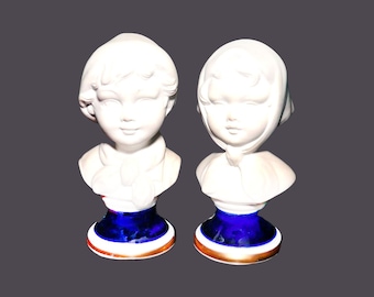 Pair of Capodimonte porcelain bisque busts. Girl in bonnet, boy in cap. Attributed to Italy manufacture Pucci.