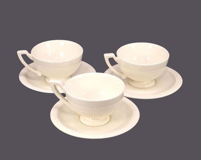 Three Royal Creamware Recamier cup and saucer sets. All cream with embossed details.