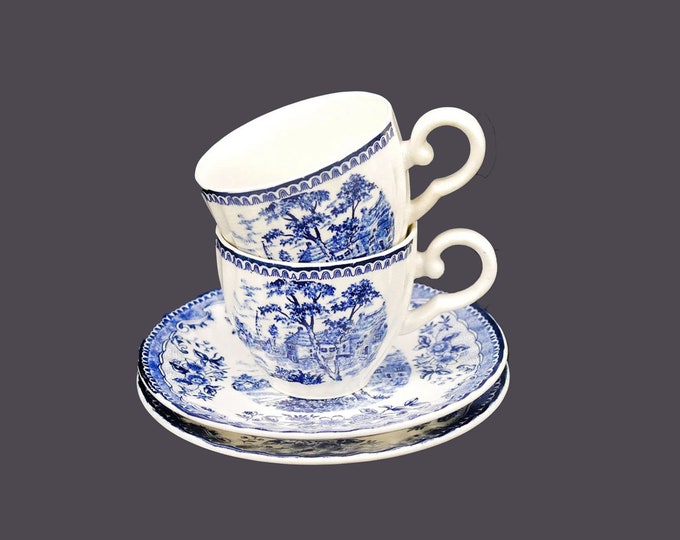 Pair of Tominaga blue-and-white cup and saucer sets made in Japan. Country landscape scene.