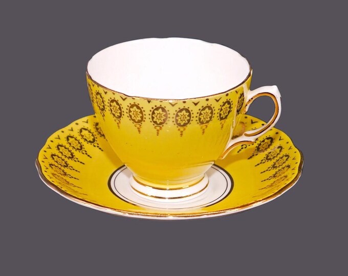 Colclough bone china cup and saucer set made in England. Sunny yellow with gold flowers and accents.