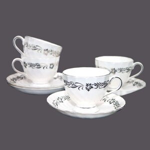 Four Tuscan China Silver Heritage cup and saucer sets made in England.