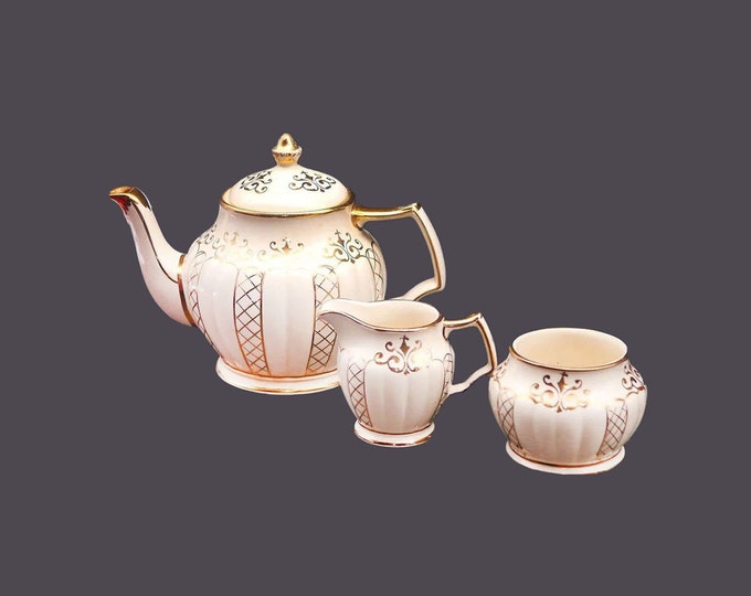 Sadler 3423 four-cup teapot, creamer and open sugar bowl set made in England. Flaw (see below).