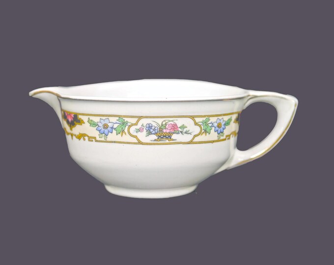 Antique Edwardian Age Wedgwood & Co. Ltd. creamer or milk jug. Imperial Porcelain made in England. Flowers in basket on yellow.