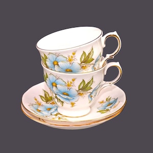 Pair of Queen Anne 8618 bone china cup and saucer sets made in England. Blue flowers on white.