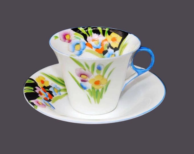 Hand-painted Nippon floral cup and saucer set. Multicolor flowers, white ground, blue handle and trim.