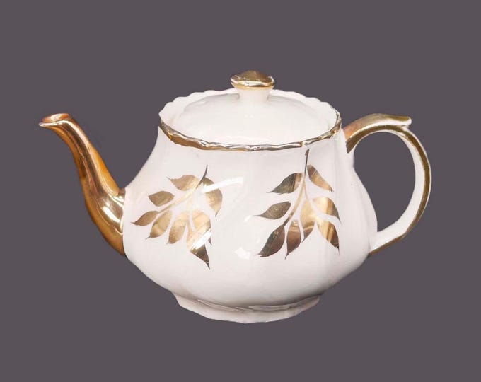 John Hamilton Sons four-cup Boston teapot marked 0215/A. Gold leaves. Made in England. Flaw (see below).