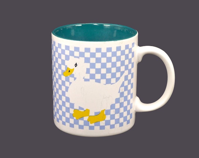 Pexim coffee or tea mug. White goose, yellow feet and beak on blue checkerboard ground. Made in Korea.