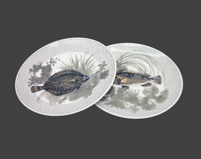 Pair of Kahla salad plates. Two different fish in black on green. Made in Germany.