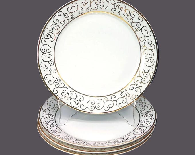 Four Holiday Joy large dinner plates. Gold scrolls on white.