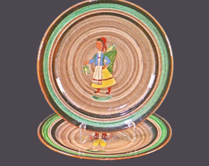 Pair of hand-painted African folk-art plates in Quimper style. Pilgrims, corn. Attributed Mwanza Tanzania Pottery. Inscribed MWZ.