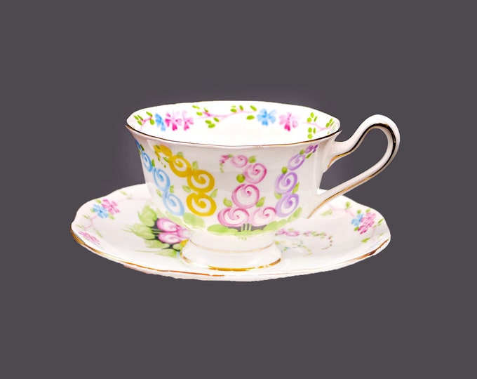 Royal Albert 2475 bone china cup and saucer set. Stylized hollyhocks. Made in England. Small flaw (see below).