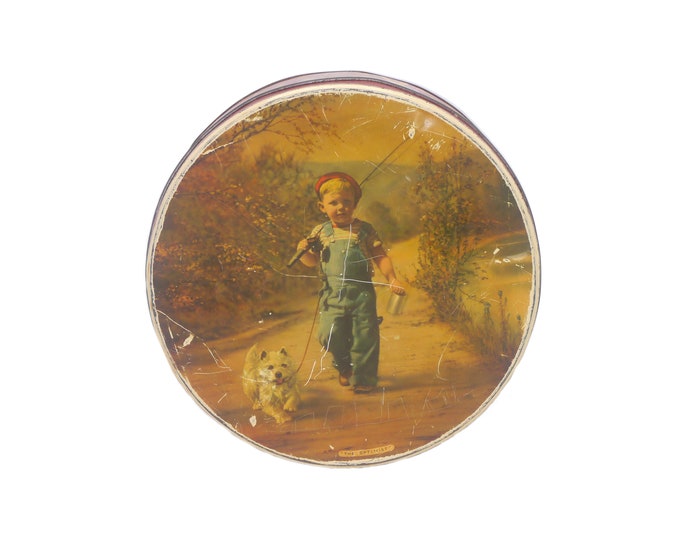 McVitie & Price The Optimist round cookie tin. Young boy and his dog go fishing. Made in England.