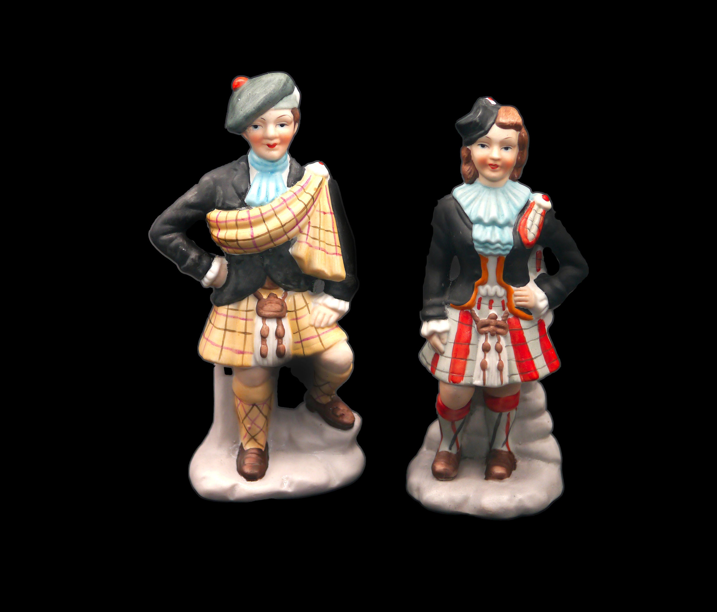 Pair of porcelain bisque Scottish lass and laddie figurines.