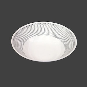 May include: White ceramic bowl with a blue and white geometric pattern around the rim.