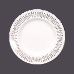 May include: White ceramic plate with a silver leaf design around the edge.