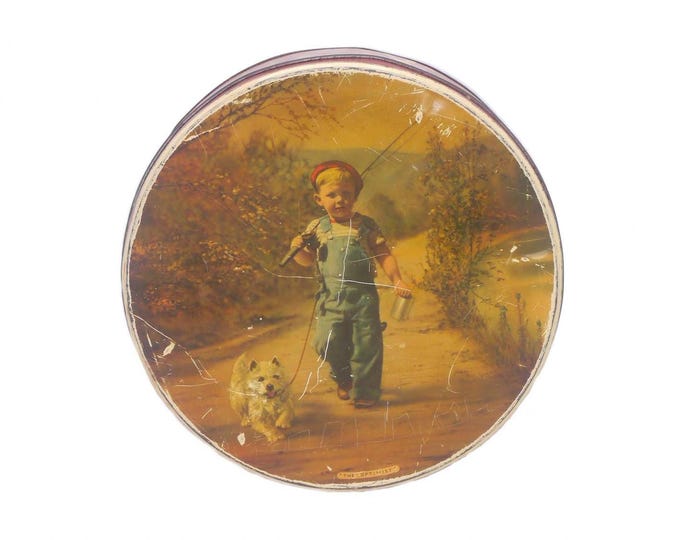 McVitie & Price The Optimist round cookie tin. Young boy and his dog go fishing. Made in England.