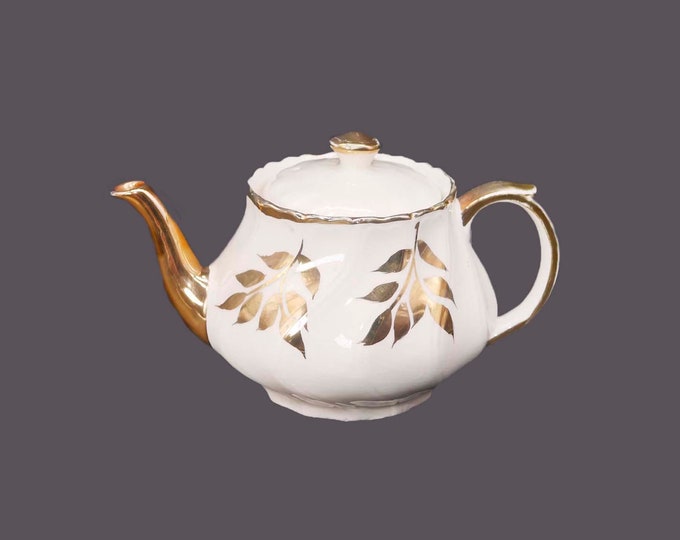 John Hamilton Sons four-cup Boston teapot marked 0215/A. Gold leaves. Made in England. Flaw (see below).