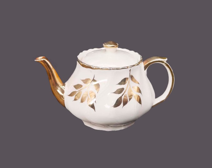 John Hamilton Sons four-cup Boston teapot marked 0215/A. Gold leaves. Made in England. Flaw (see below).