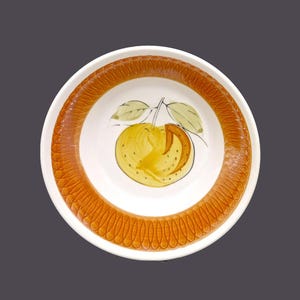 May include: A white ceramic bowl with an orange rim and a painted orange design. The orange is yellow with brown highlights and green leaves.