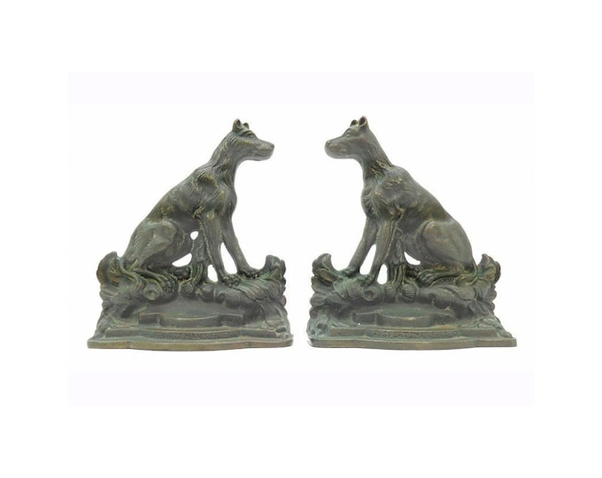 Pair of Antique cast iron dog book ends A Sportsman's Friend by artist Emanuel Hahn. Bronze patina, felt covering to bases.
