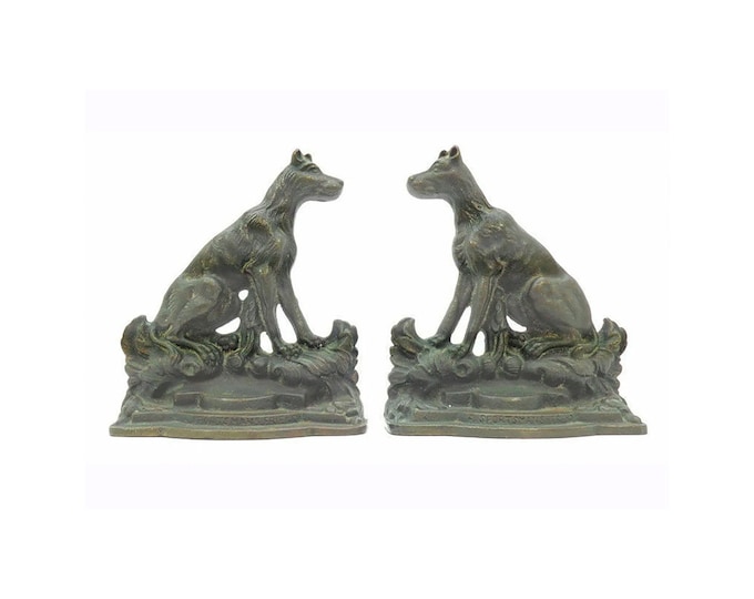 Pair of Antique cast iron dog book ends A Sportsman's Friend by artist Emanuel Hahn. Bronze patina, felt covering to bases.