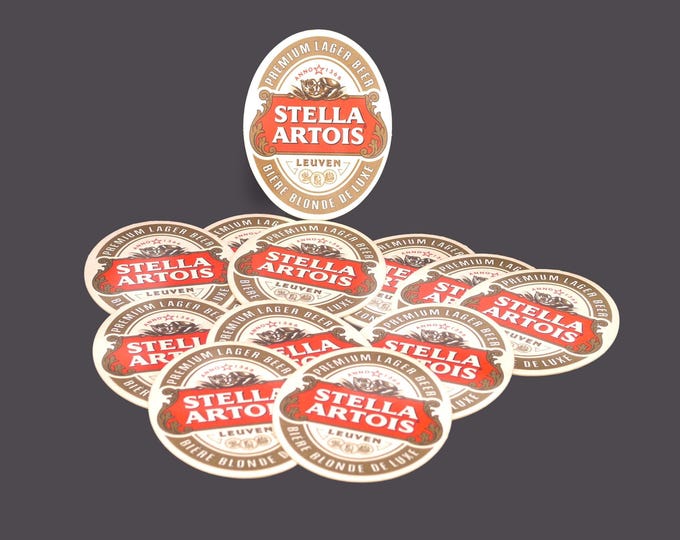 Twelve Stella Artois Biere Blonde Deluxe oval cardboard coasters. Great home bar decor.