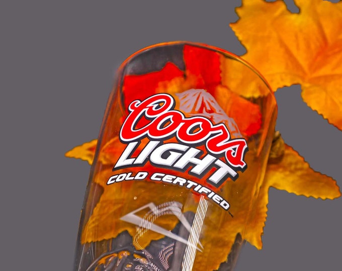 Coors Light "Cold Certified" beer pint glass. Etched-glass branding, weighted base, embossed details. Commercial-quality glassware.